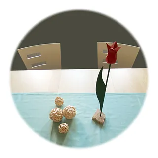 Ein Tisch mit zwei Stühlen und einer Blume