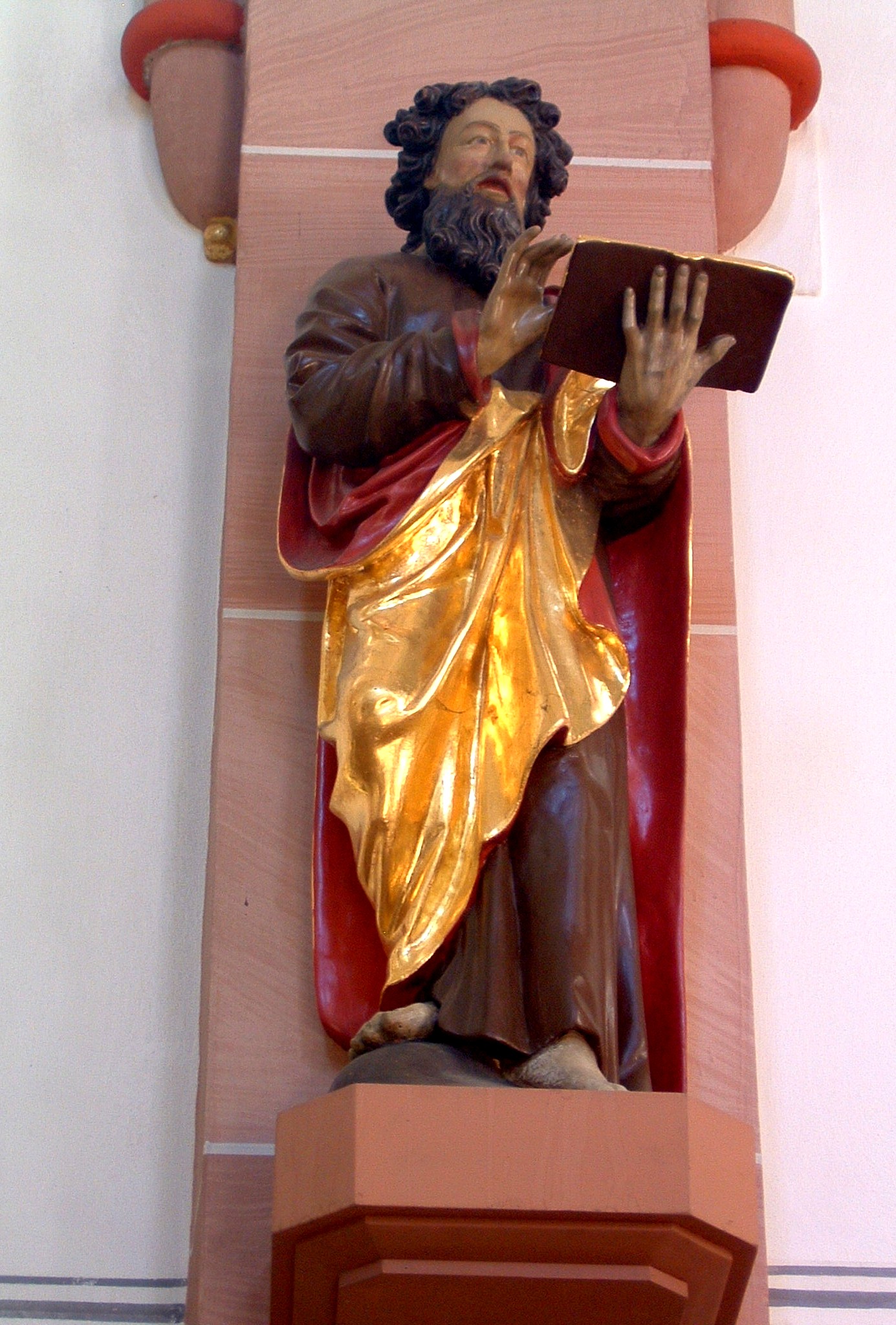 Statue vom Hl. Bartholomäus mit Buch in der Hand, auf einem Sockel